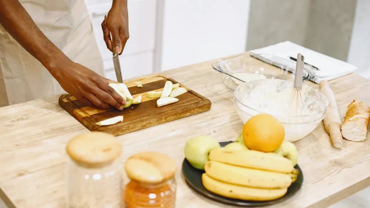 A dog sniffing banana slices arranged on a kitchen counter