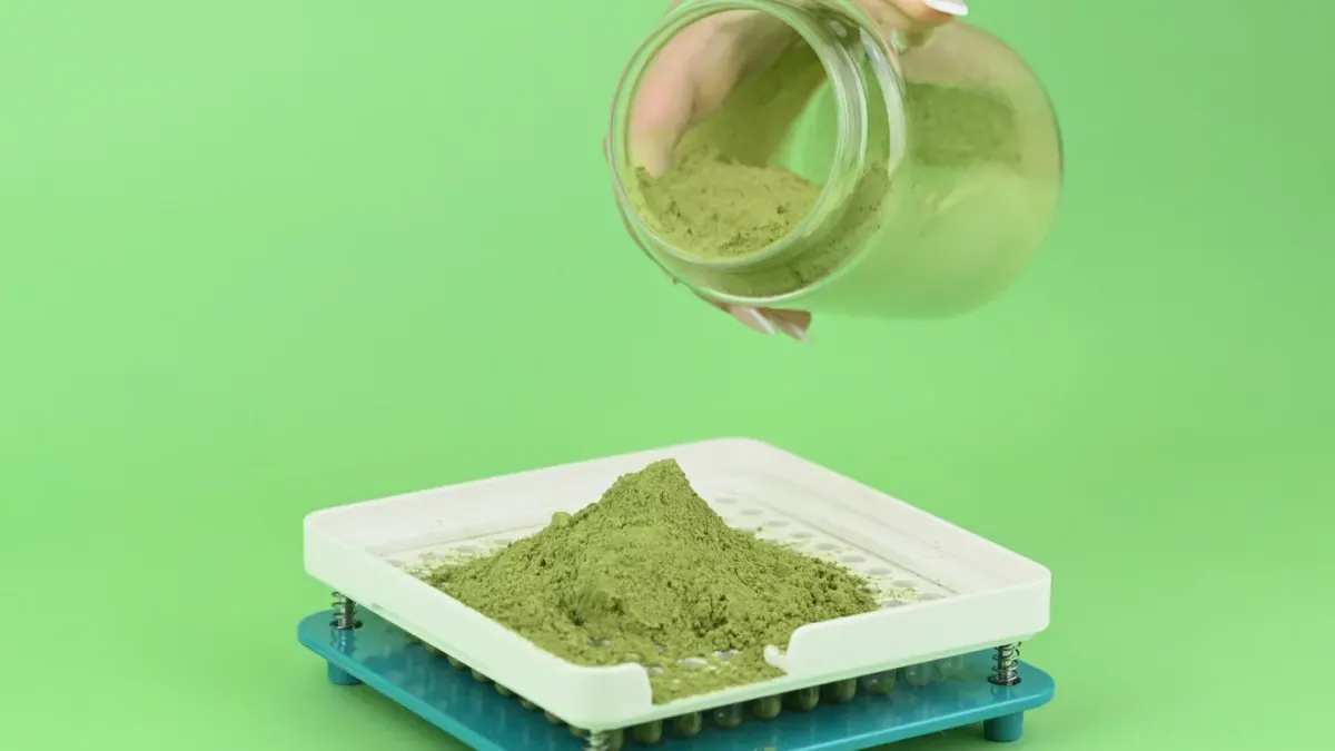 A scoop of powdered dog supplement next to a jar of freeze-dried pieces on a kitchen counter