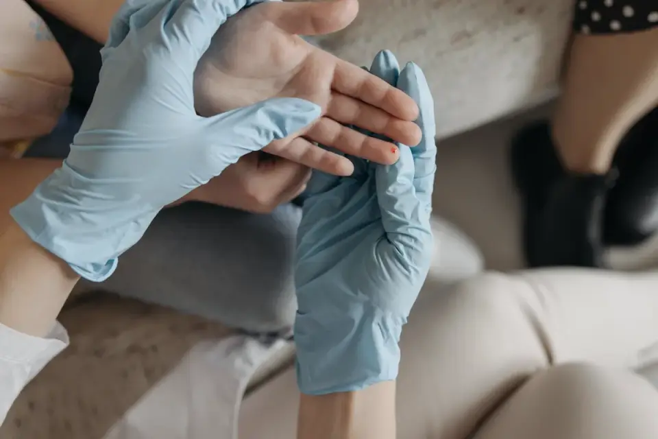 A veterinarian gently examining a puppy&#x27;s front leg on an exam table