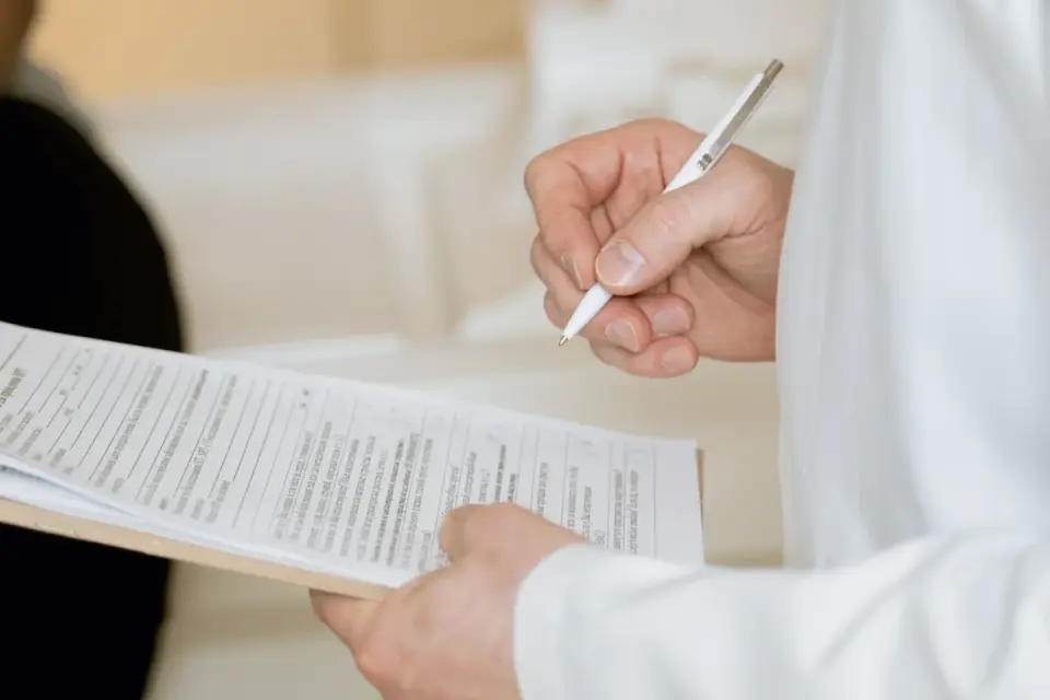 A veterinarian reviewing lab results with a dog owner in an exam room