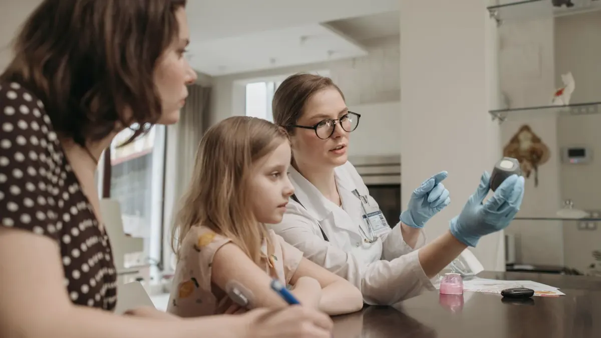 A veterinarian showing a dog supplement bottle to a pet owner during an exam room visit
