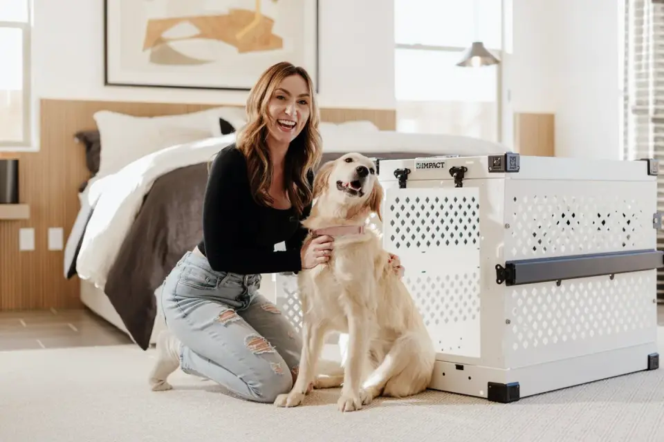 An appropriately sized wire crate set up with padded bedding