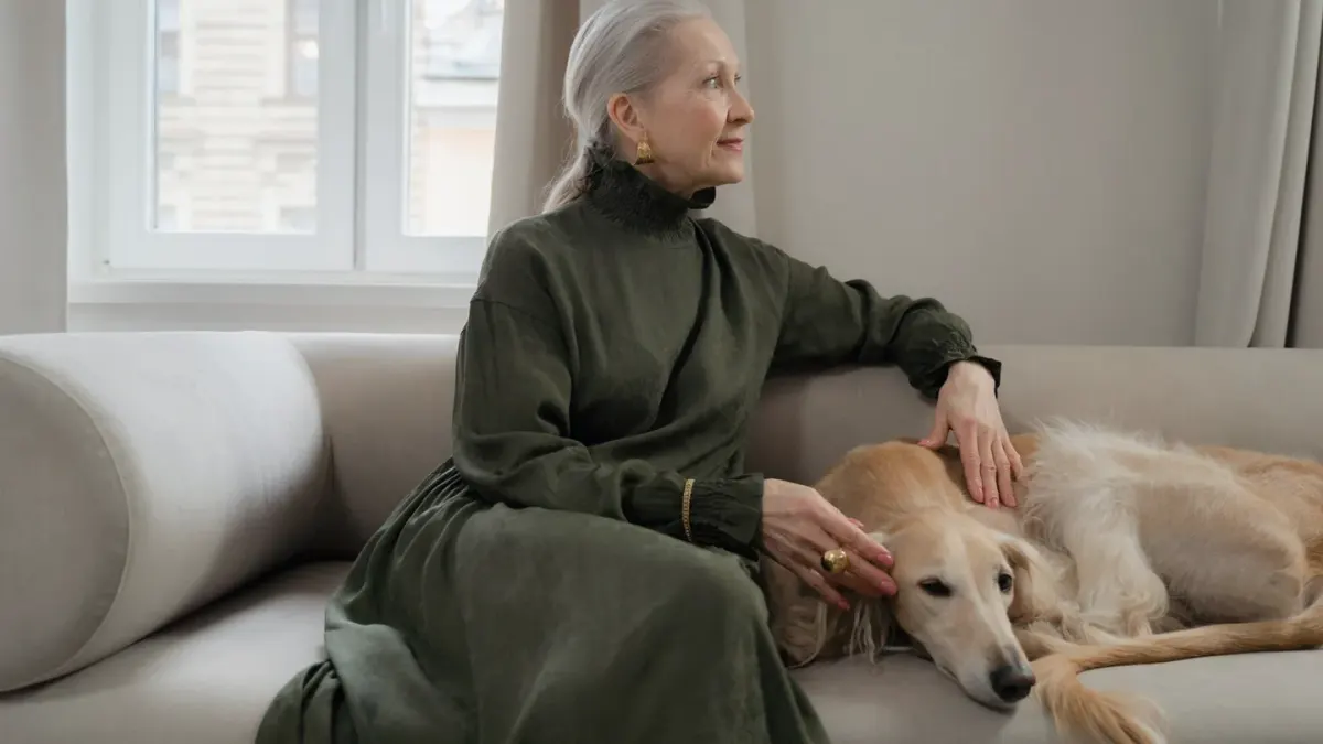 Dog resting beside an owner