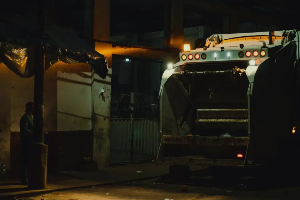 Garbage truck lifting a bin on a quiet residential street