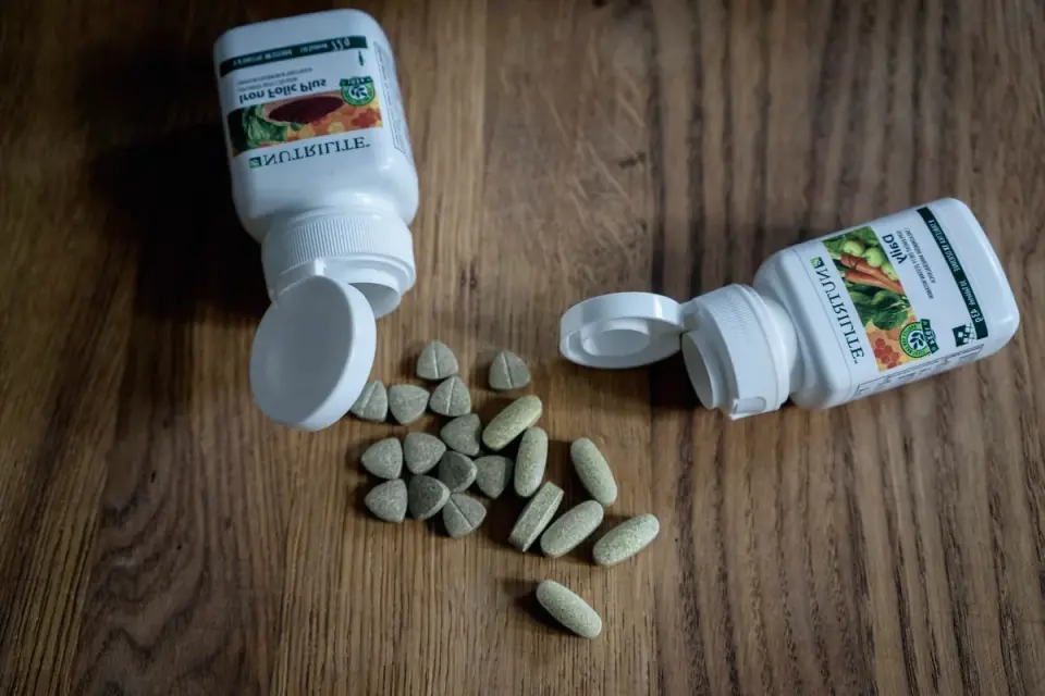 Several dog supplement bottles lined up on a kitchen counter