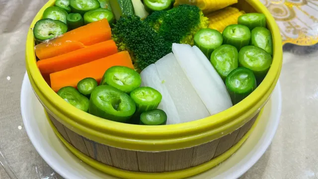 Steamed broccoli florets cut into small pieces sitting beside a dog's bowl
