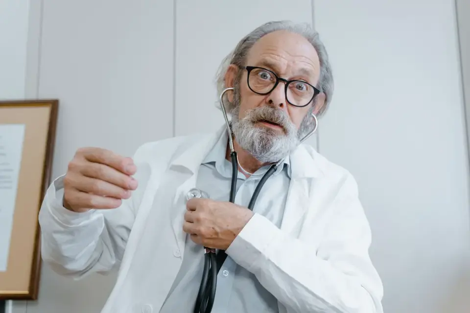 Veterinarian listening to an older dog's heart with a stethoscope during an exam