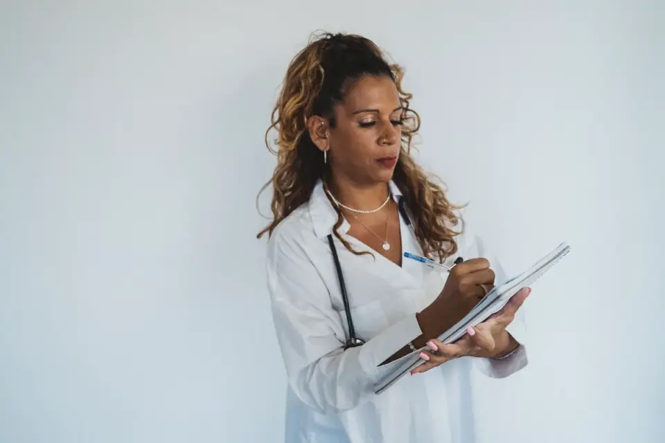 Veterinarian reviewing bloodwork results with a dog patient nearby